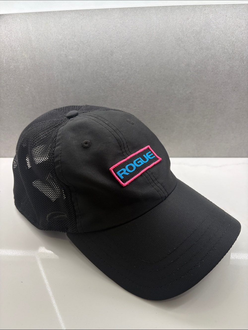 Rogue Men’s Hat - Black Mesh Cap with Pink-Edged Blue Logo